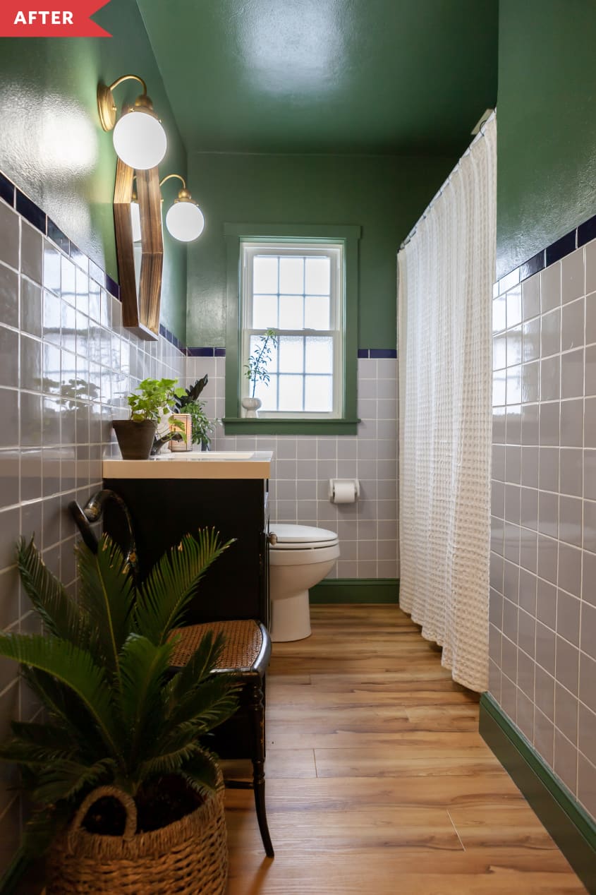 After: Bathroom with wood-look floors, green walls and ceiling, and gold sconces