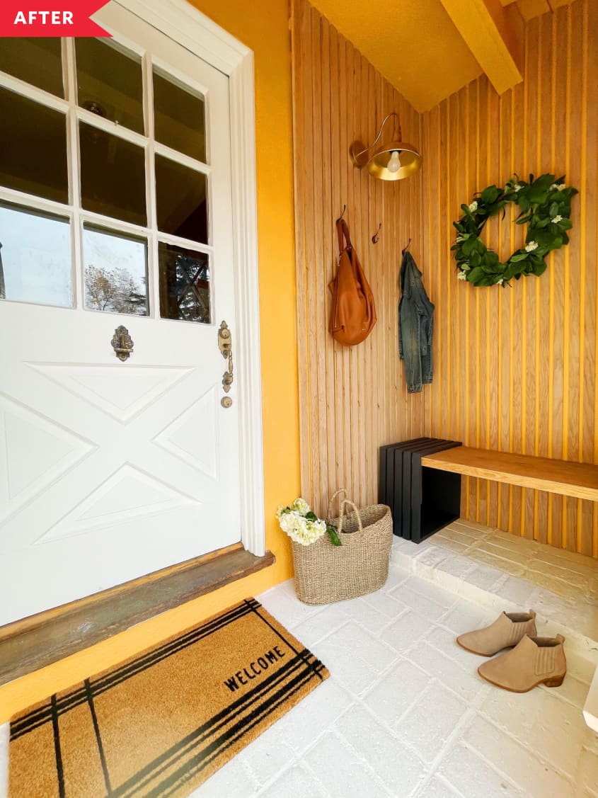 After: Slatted wood entryway with orange accents and a wood bench