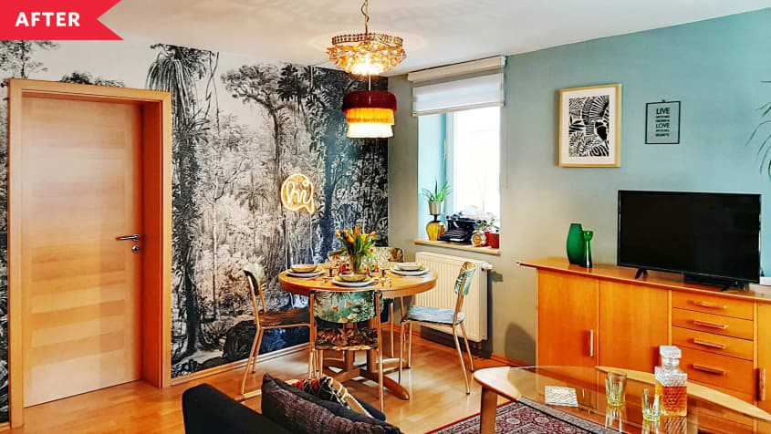 After: living room with blue accent wall, forest wallpaper, and eclectic decor