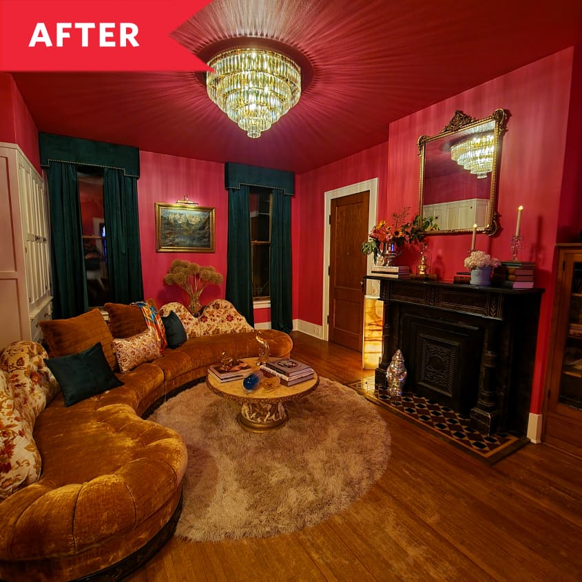 After: Glam living room with red walls, glass chandelier, and rounded velvet sofa