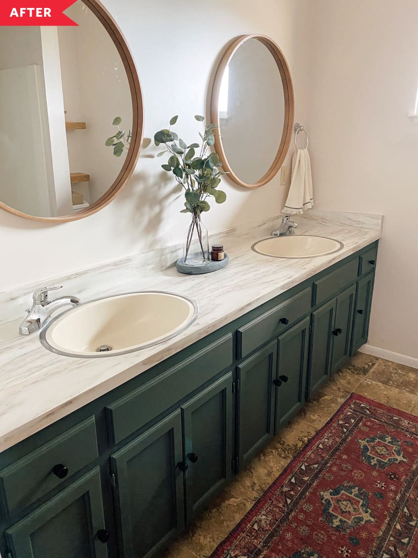 After: Painted green vanity with black knobs, with round wood framed mirrors above