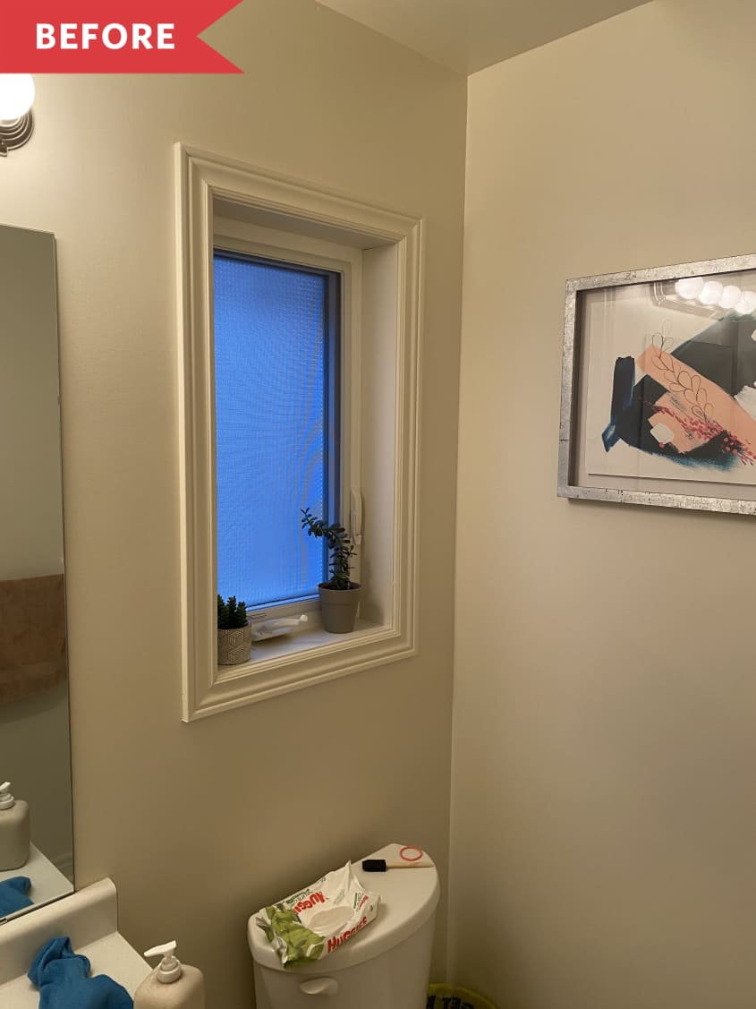 bathroom with gray walls and a window above the tiolet