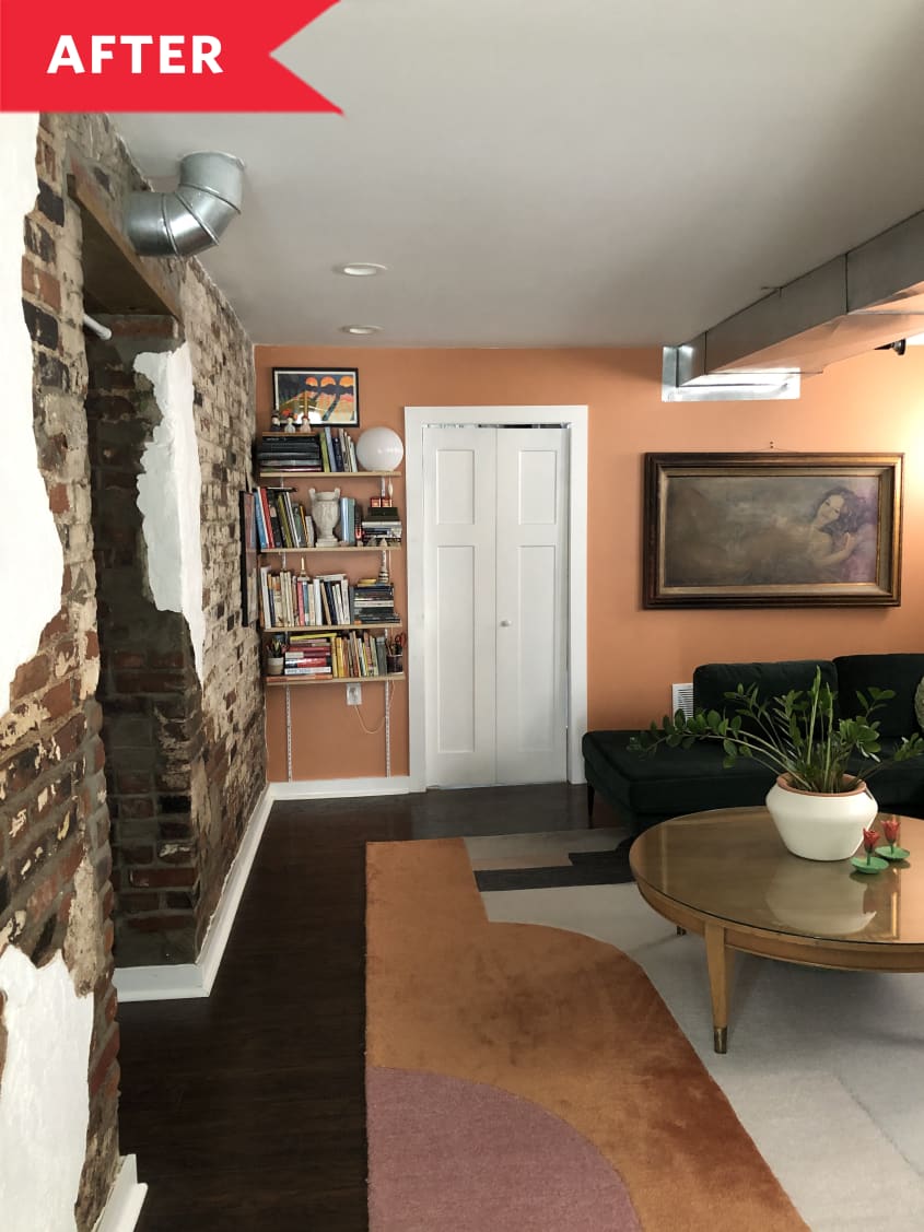 After: Living room with orange walls and exposed brick