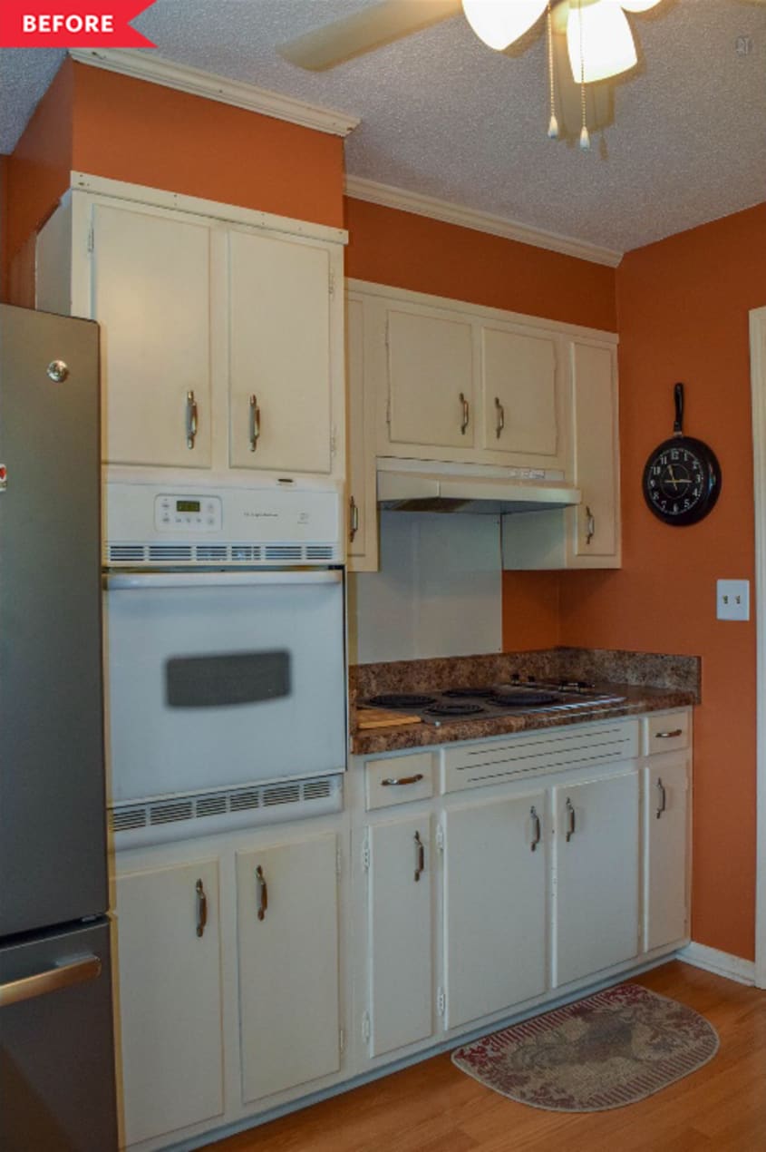 Before: kitchen with white cabinets and muted orange walls