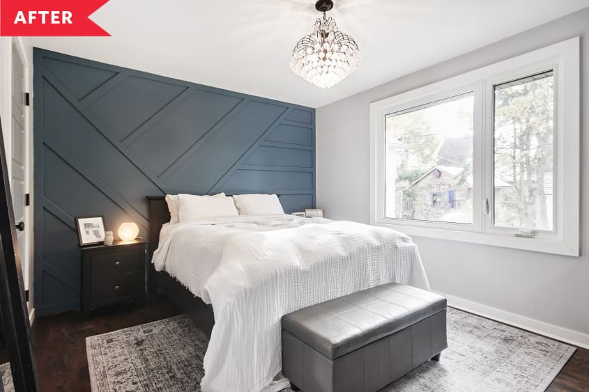 After: gray bedroom with blue geometric wood accent wall and dark wood floors