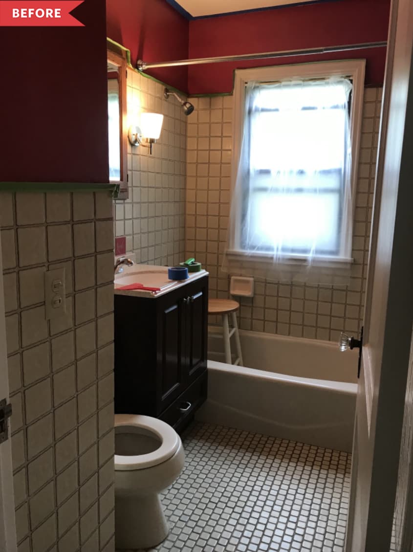 Before: Bathroom with white square tile and red paint on the walls, plus dark wood vanity