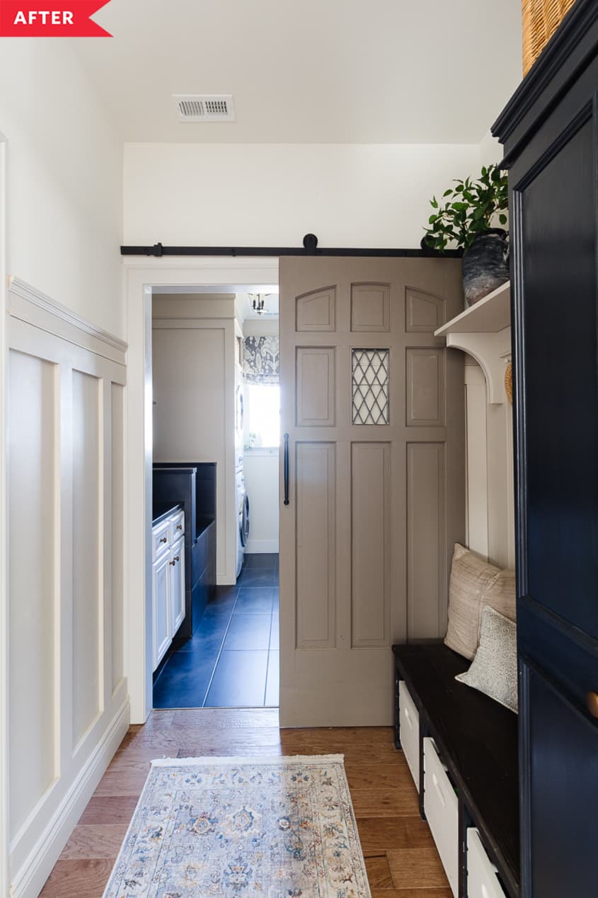 After: Mudroom with black built-ins, tan board-and-batten, and a sliding tan door