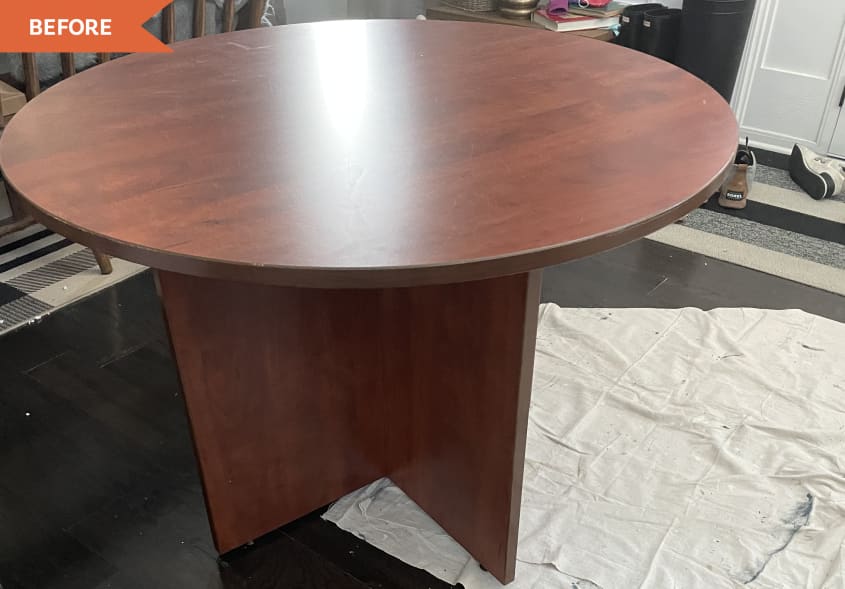 Before: Round laminate table with a shiny red-toned wood finish