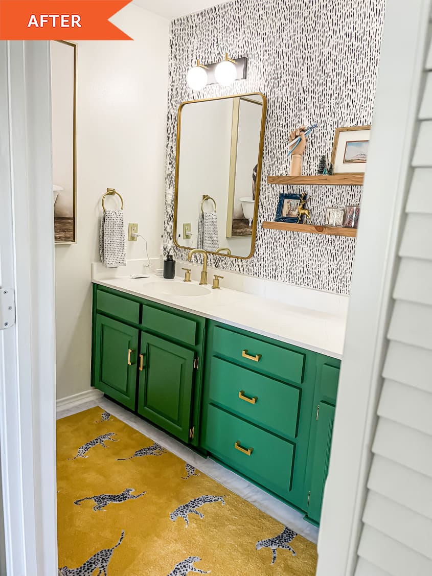 Bathroom with green cabinets and spotted walls