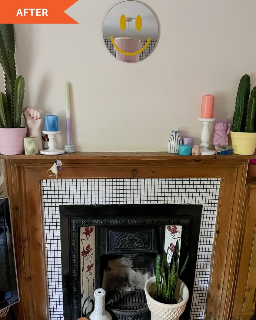 After: a wooden fireplace with cacti and a smiley face mirror above