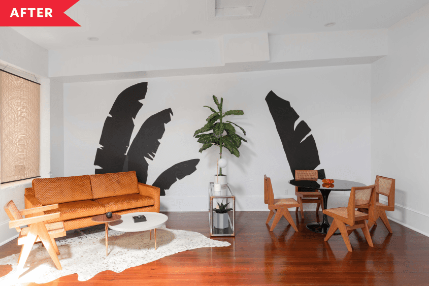 office space with plants painted on walls after renovations, brown leather couch in center