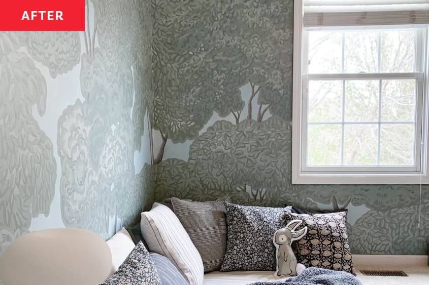 After: pillows lined along the corner of a wall with tree wallpaper