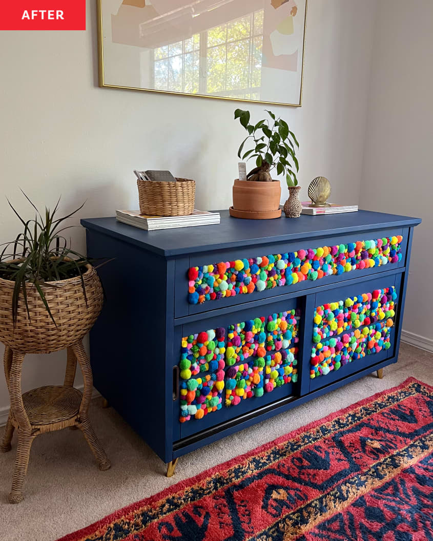After photo of a dresser that has been refurbished/diy with deep blue paint. The front of the dresser has been covered with colorful poms