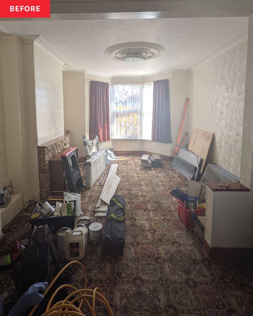 Living room before renovation/makeover. Old, dark patterned carpet, off white textured walls