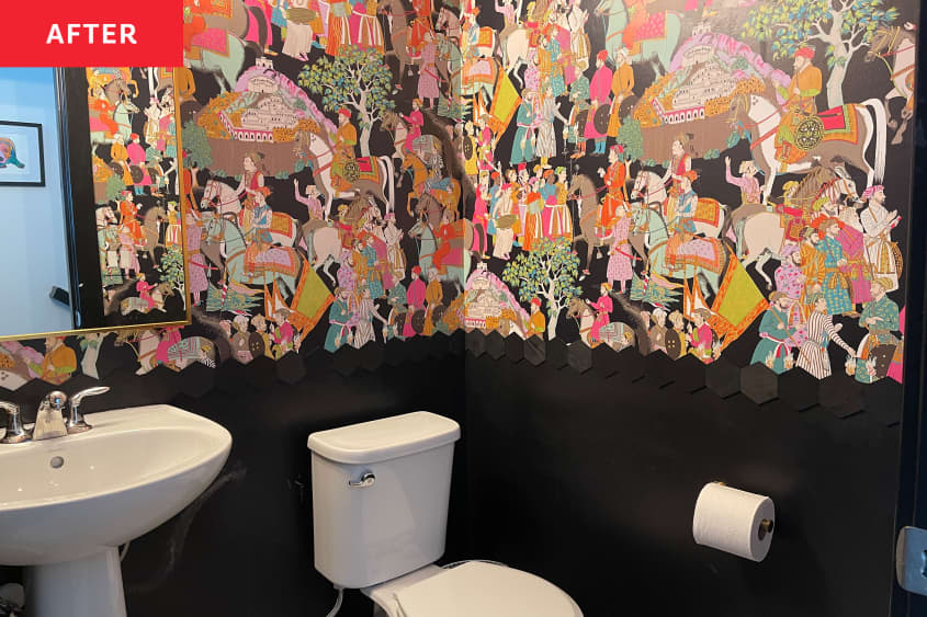 Black bathroom with colorful wallpaper after renovation.