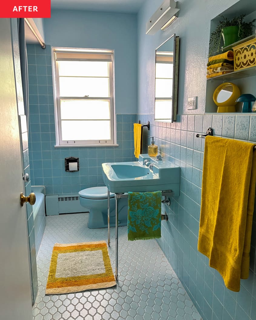 Blue bathroom after restoration with vintage faucet and toilet.