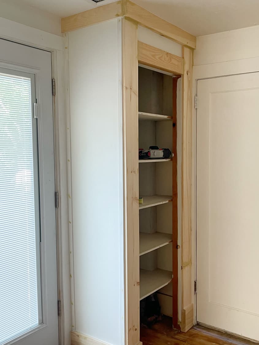 Closet with trim around opening and at ceiling height