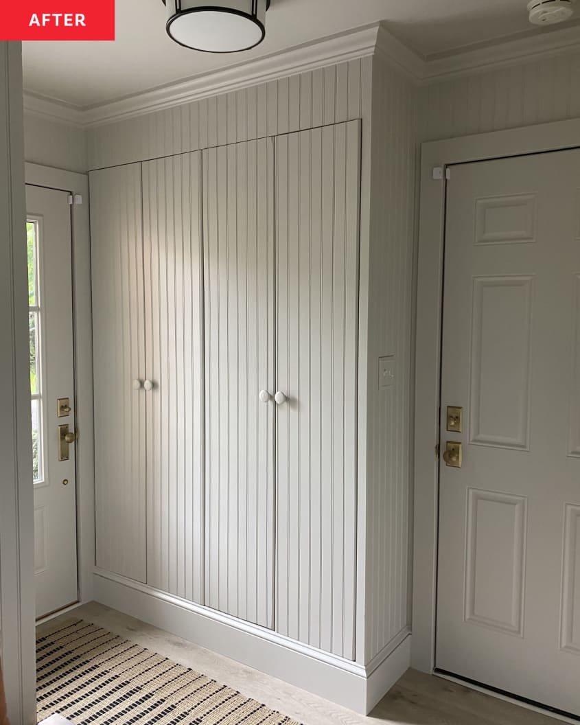 white tongue and groove paneling, wood floors, beige and black runner,  molding,  white door, closets
