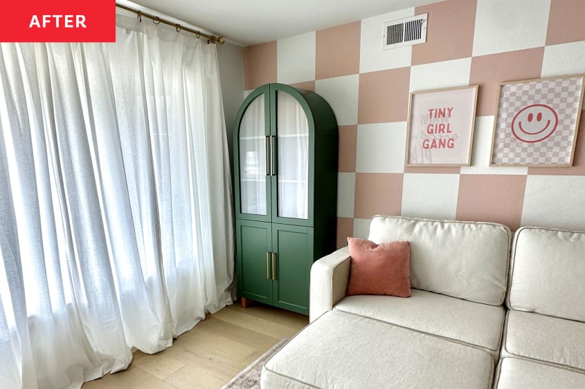 Green curio cabinet in corner of pink and white checkerboard painted playroom.