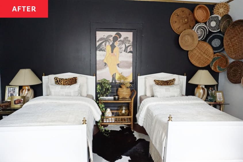 Two beds against black accent wall with woven baskets.