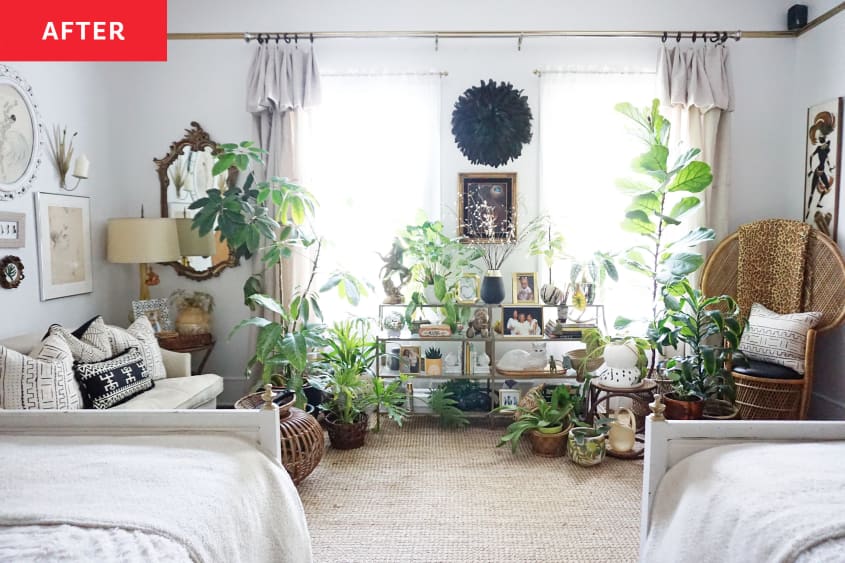 Two beds overlook plants, white love seat next to glass shelves.