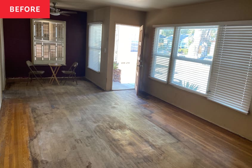 Living and dining area of home with badly damaged  hardwood floors.