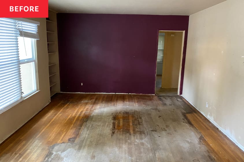 Eggplant color painted bedroom with badly damaged floors before renovation.