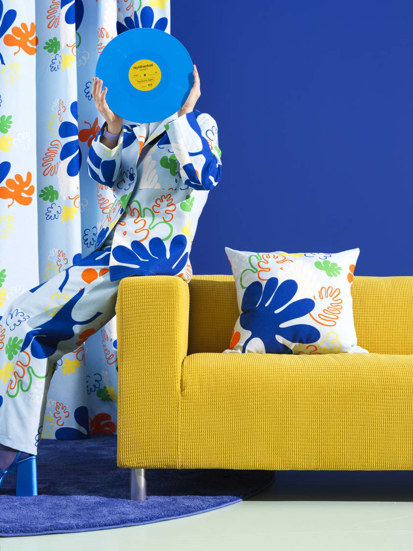 Colorful studio photo of items from the IKEA 80th anniversary Nytillverkad collection - printed curtains and pillow