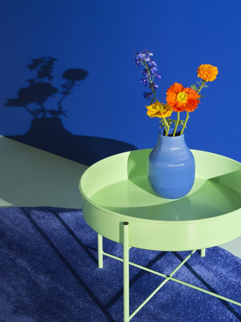 Colorful studio photo of items from the IKEA 80th anniversary Nytillverkad collection - mint green round side table