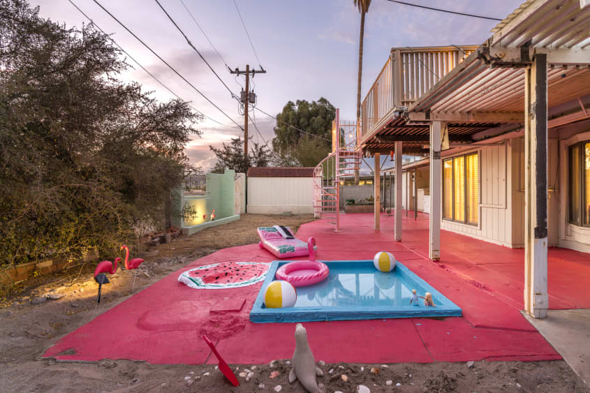 Back yard with small pool and inflatable pool toys