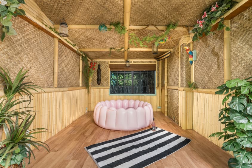 Rattan enclosed porch with pink inflatable pool