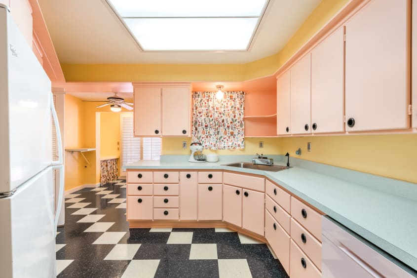 kitchen with peach cabinets, pale blue countertops, and black and white checked floor