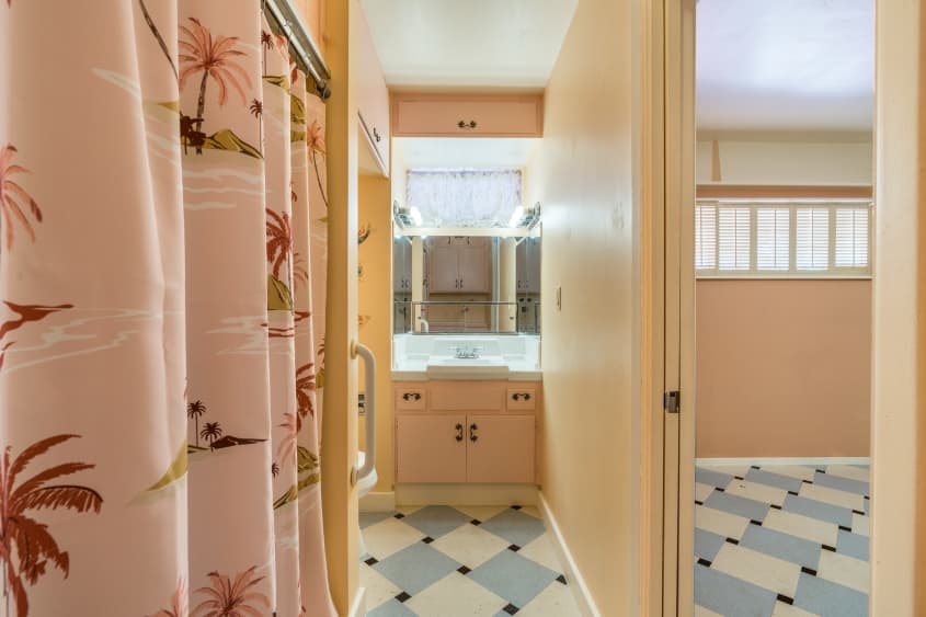 peach colored bathroom with blue and white tile