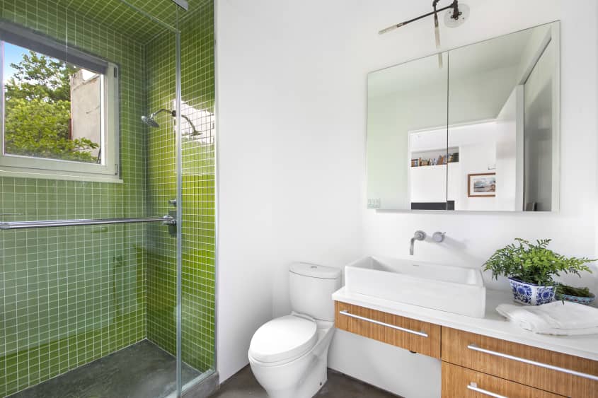Modern bathroom with green tiled standing shower