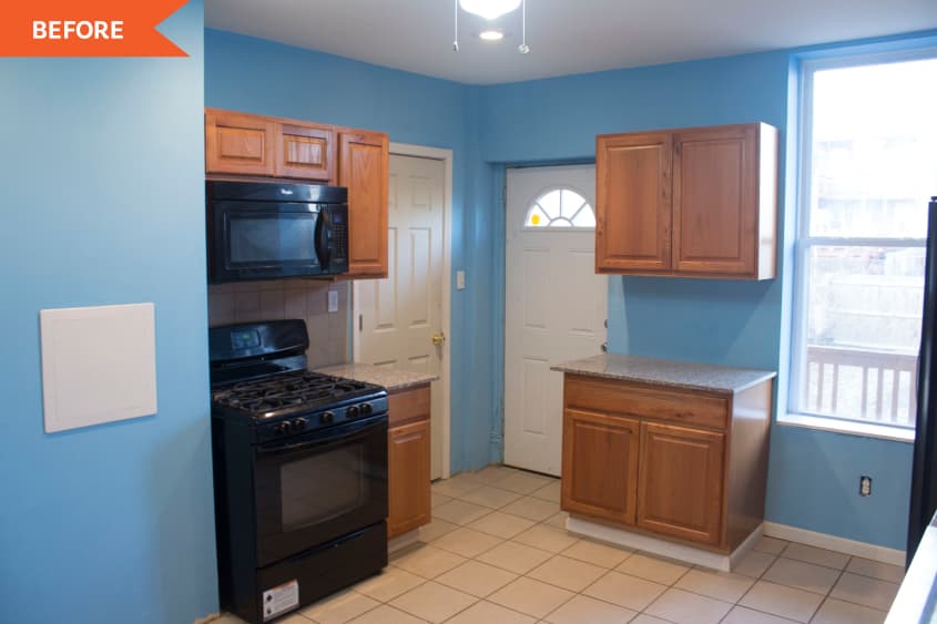 Kitchen before with wood cabinetry and blue walls