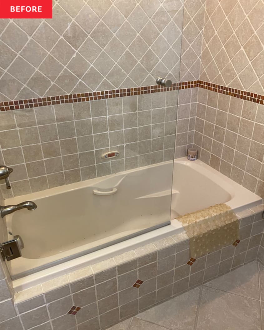 Bathroom before renovation/makeover: brownish gray tiles on lower half of wall and in shower, glass shower sliding doors, drab warm gray tile floor