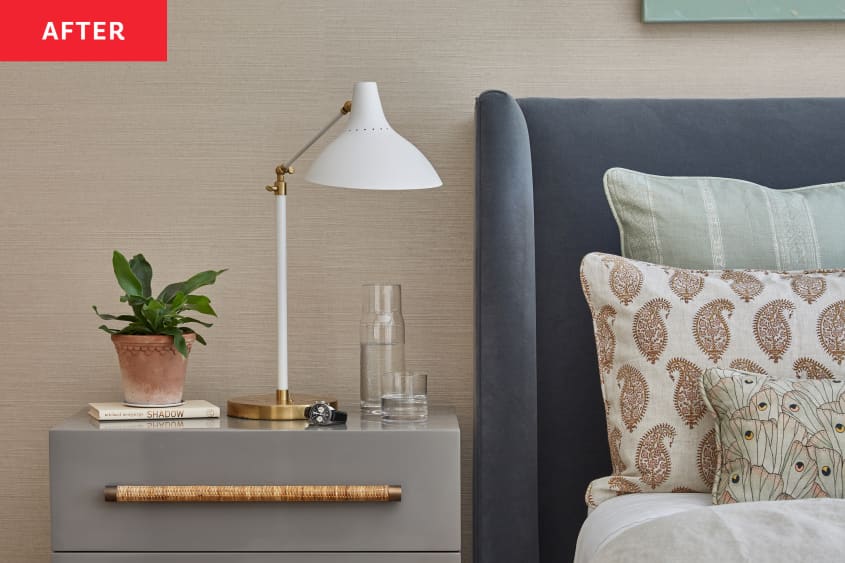 Task lamp on grey nightstand with natural grass woven handles in newly renovated bedroom.