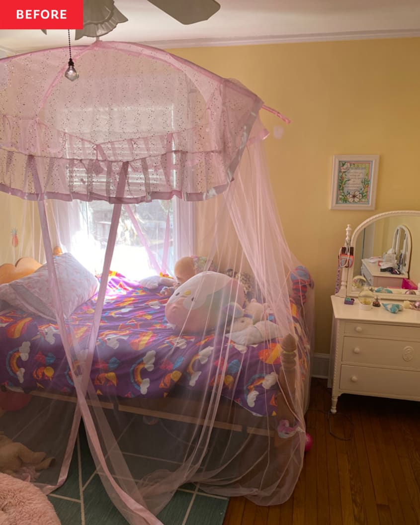 canopy bed, canopy pink netting, wood floors, yellow walls, dark purple multi colored patterned comforter, child's dresser, attached mirror to dresser, ceiling fan