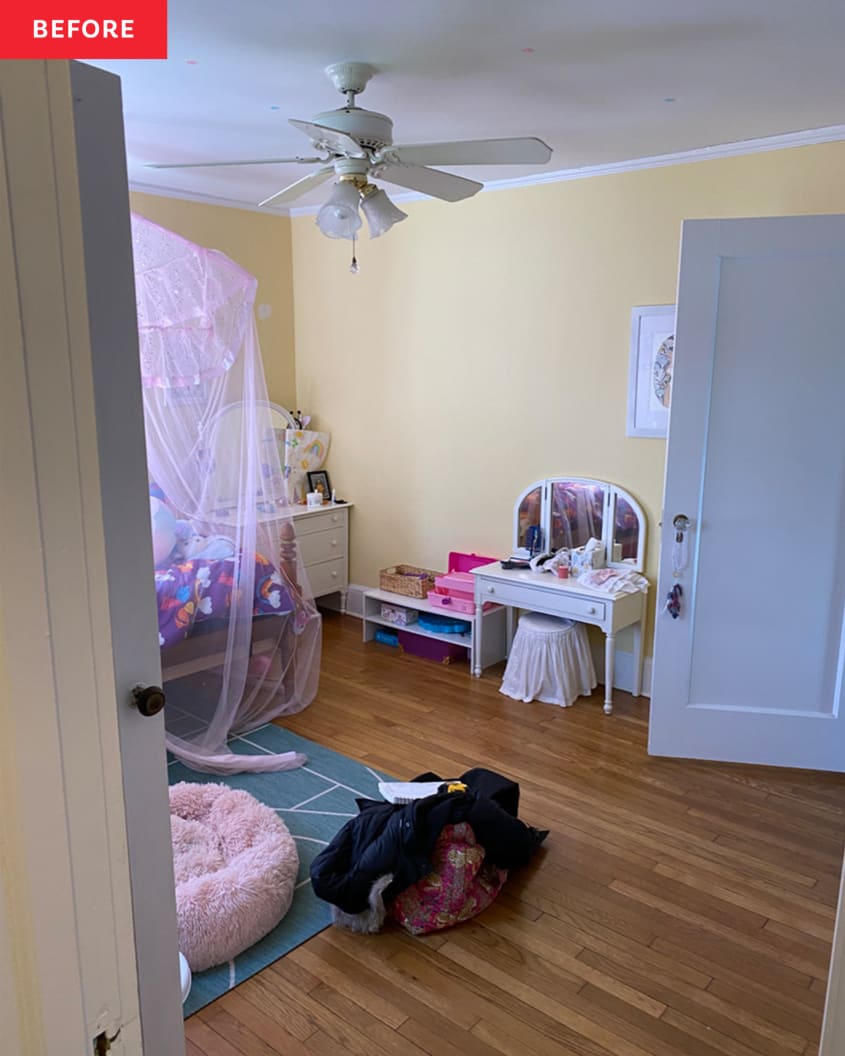 child's vanity, small mirror, wood floors, pink dog bed, blue rug, canopy bed, canopy pink netting, yellow walls, ceiling fan, purple multi colored comforter