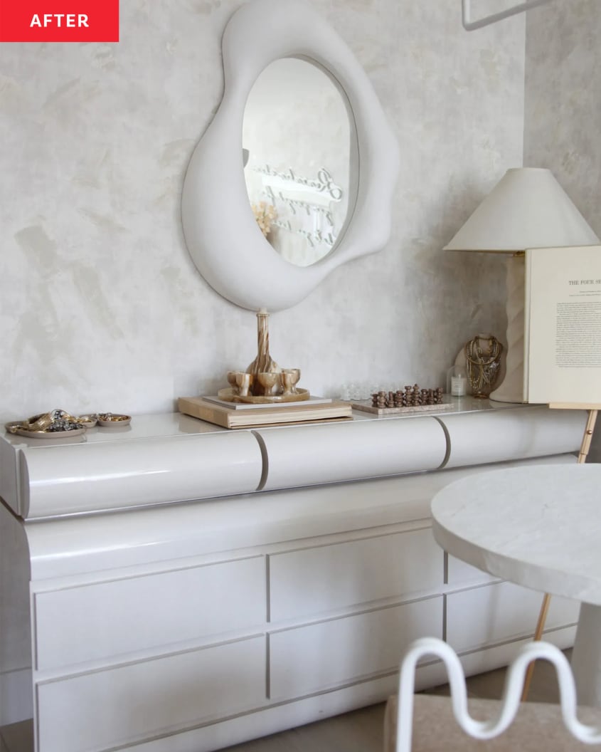 A white dresser in a white  limewashed room.