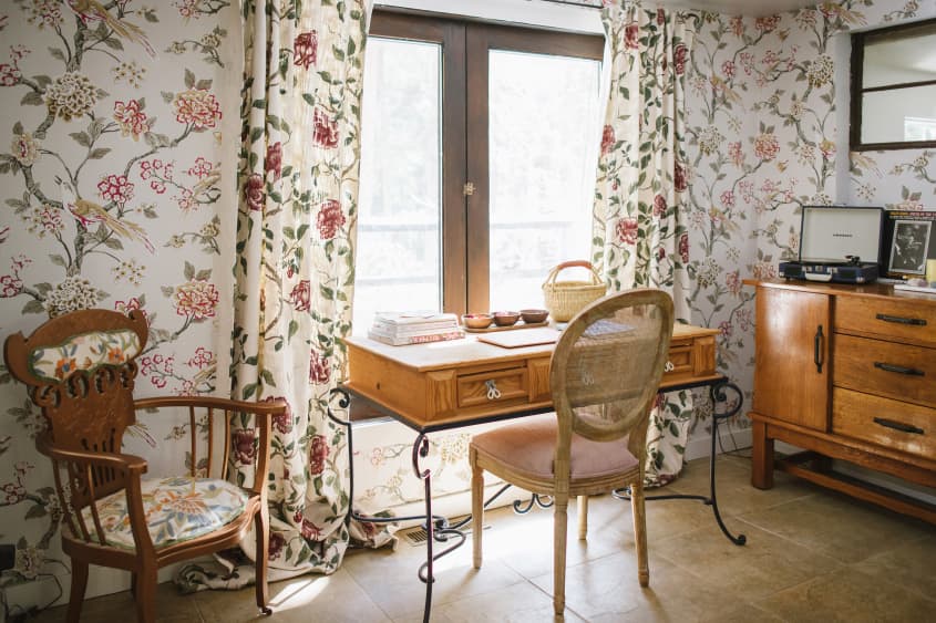 desk and credenza and chair in floral wallpaper patterned room