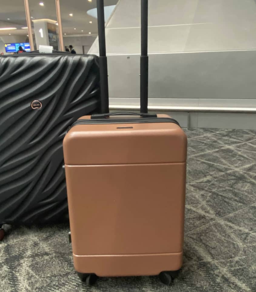 brown carry-on suitcase in airport