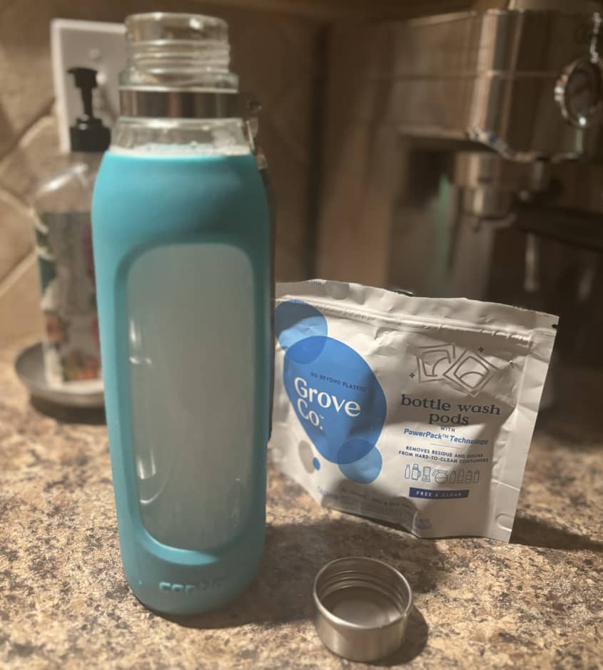 blue water bottle being cleaned with a pod
