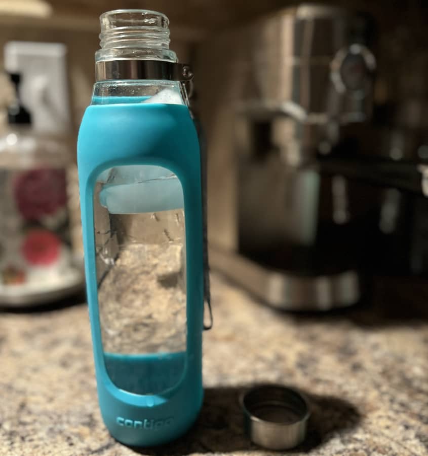blue water bottle being cleaned with a pod