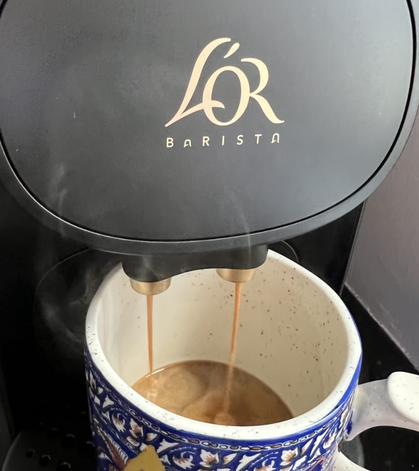 L'OR black coffee machine brewing a cup