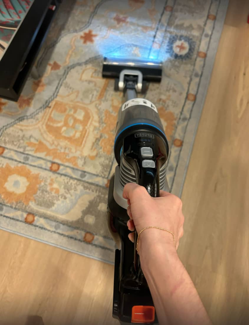someone using the BLACK+DECKER POWERSERIES Extreme MAX Cordless Stick Vacuum at home