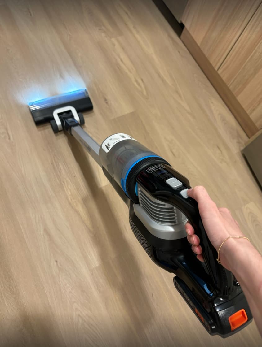 someone using the BLACK+DECKER POWERSERIES Extreme MAX Cordless Stick Vacuum at home