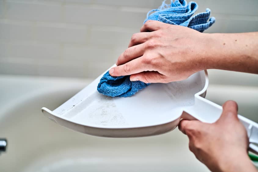 wiping dustpan with a microfiber cloth