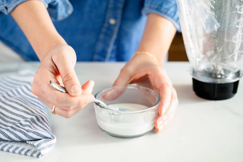 Making a thick paste of baking soda and water in a bowl