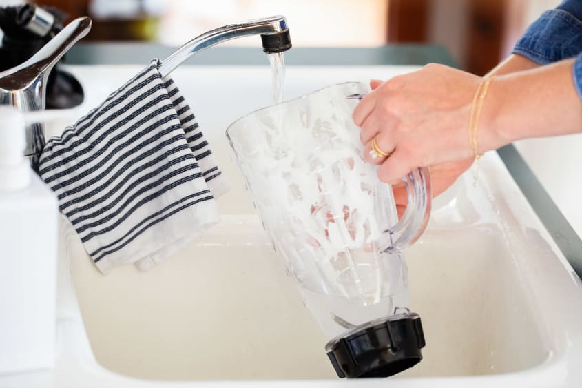 Rinsing the blender cavity in the kitchen sink